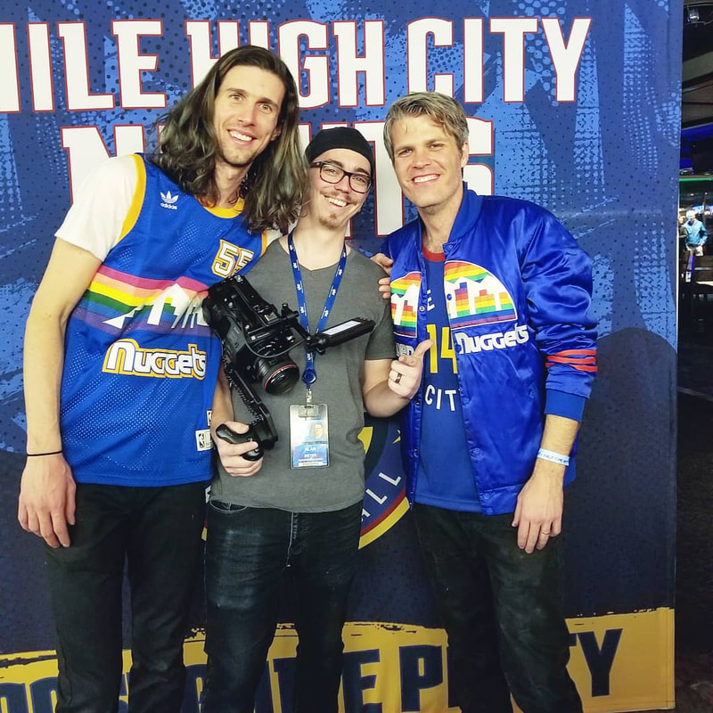 Alan Meyer posing with music group 3OH!3 after performance at Denver Nuggets game. 