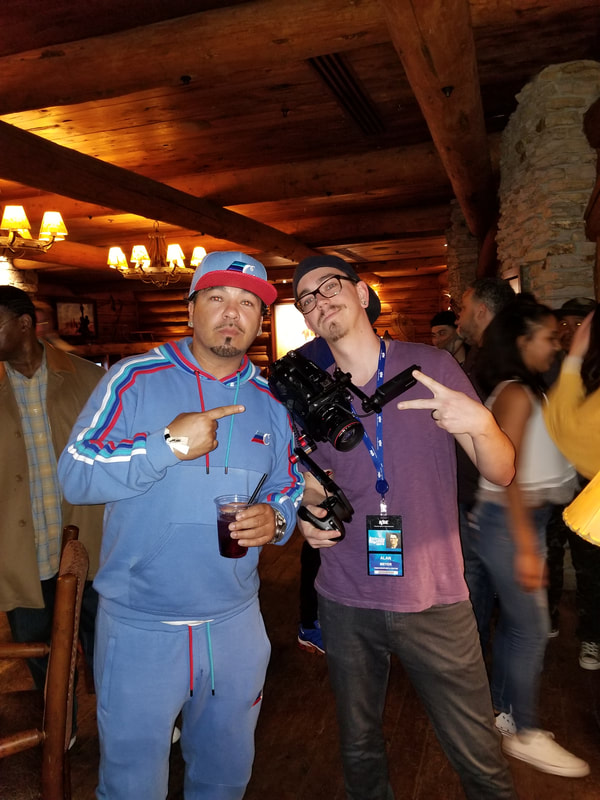 Alan Meyer posing with musician Baby Bash after performance at Denver Nuggets game. 